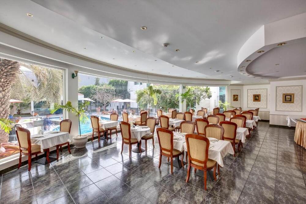 Restaurant dining room with views over the garden and pool