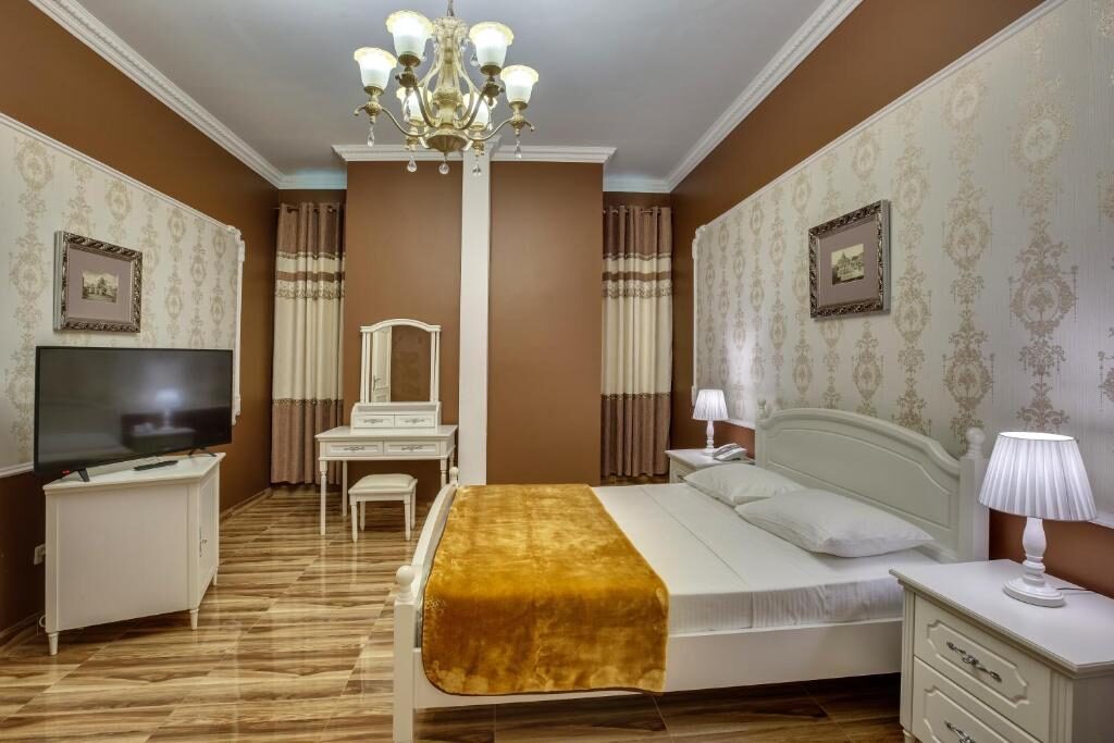 Family room with a chandelier and a large bed