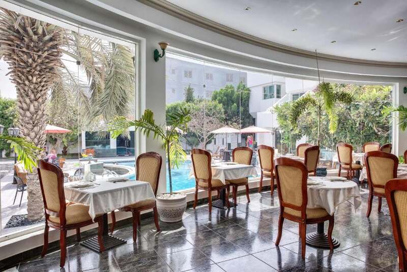 Restaurant tables beside the pool windows